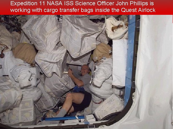 Expedition 11 NASA ISS Science Officer John Phillips is working with cargo transfer bags