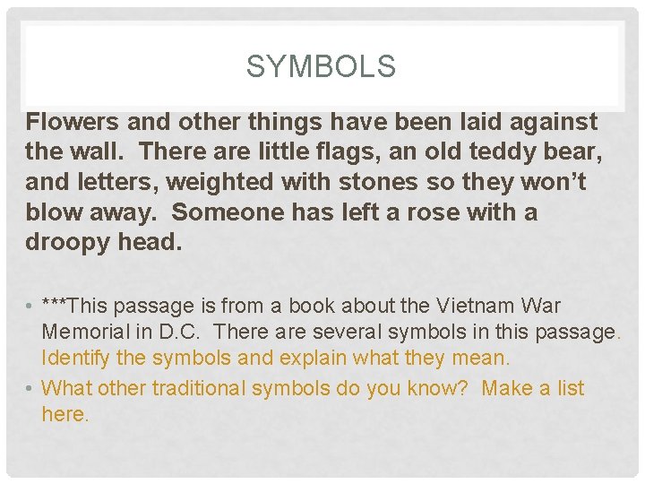 SYMBOLS Flowers and other things have been laid against the wall. There are little