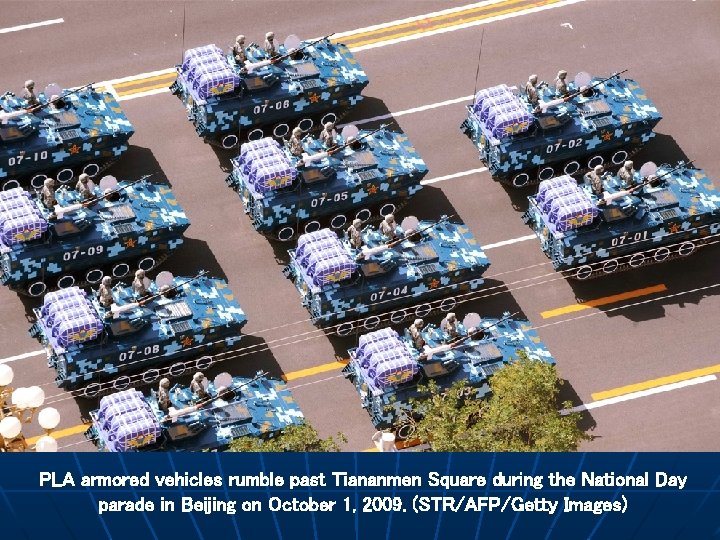 PLA armored vehicles rumble past Tiananmen Square during the National Day parade in Beijing