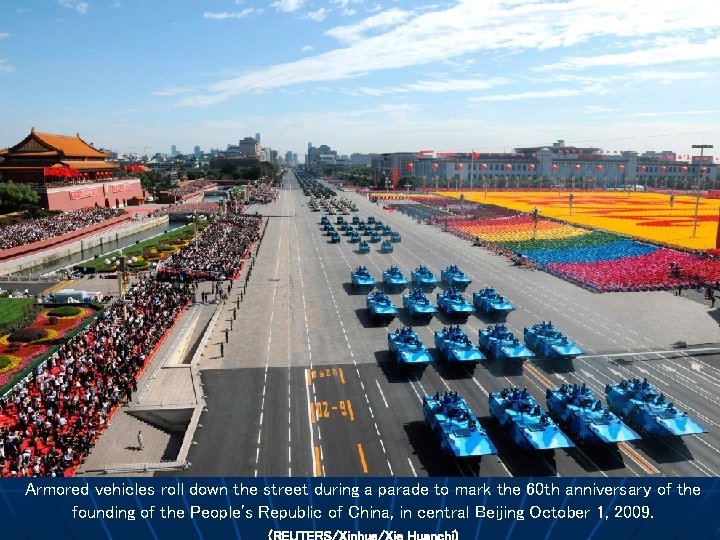 Armored vehicles roll down the street during a parade to mark the 60 th