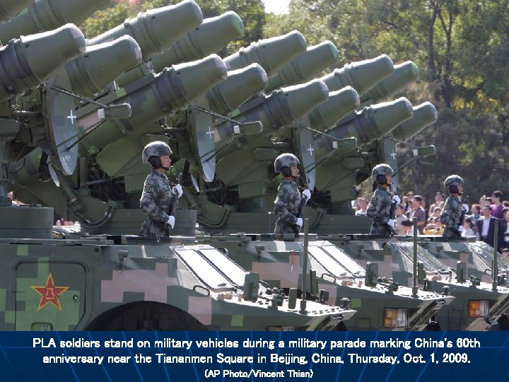 PLA soldiers stand on military vehicles during a military parade marking China's 60 th