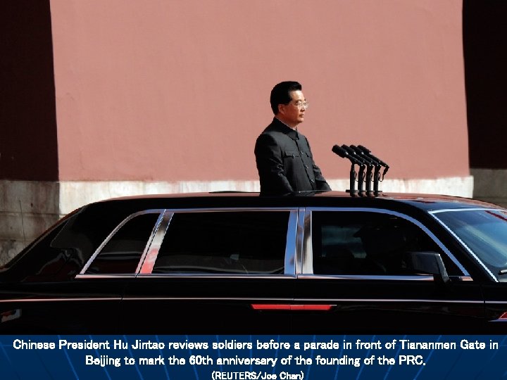Chinese President Hu Jintao reviews soldiers before a parade in front of Tiananmen Gate