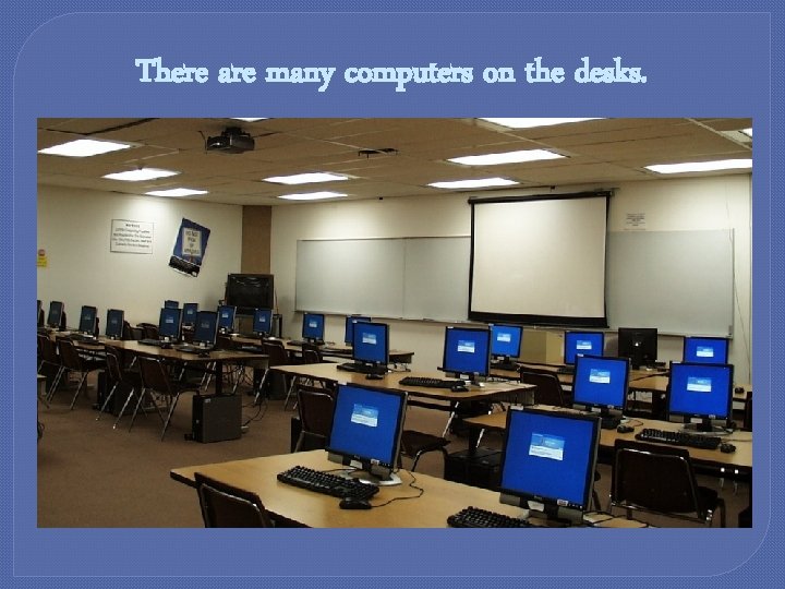 There are many computers on the desks. 