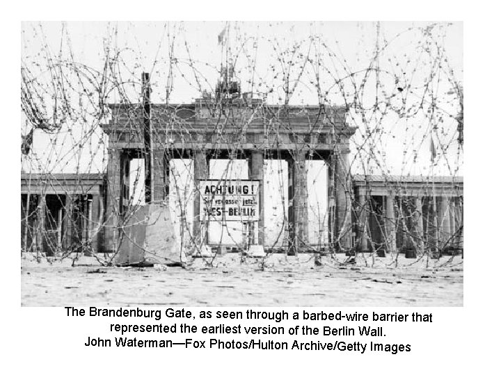 The Brandenburg Gate, as seen through a barbed-wire barrier tha t represented the earliest