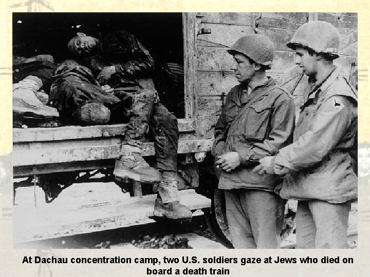 At Dachau concentration camp, two U. S. soldiers gaze at Jews who died on