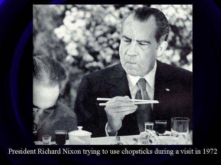 President Richard Nixon trying to use chopsticks during a visit in 1972 