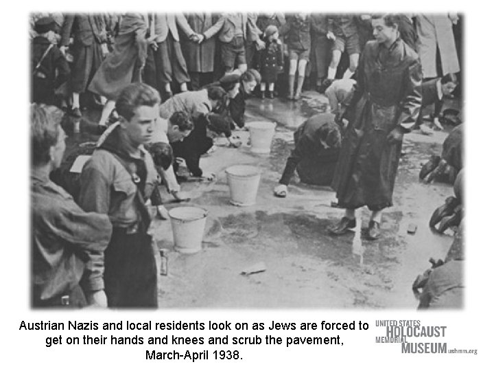 Austrian Nazis and local residents look on as Jews are forced to get on