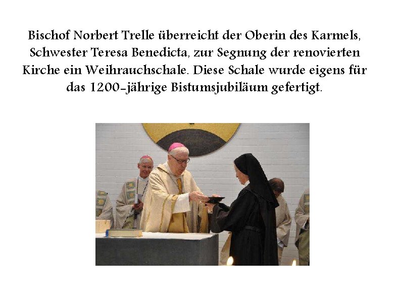 Bischof Norbert Trelle überreicht der Oberin des Karmels, Schwester Teresa Benedicta, zur Segnung der