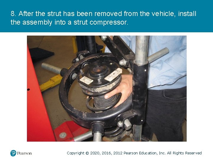 8. After the strut has been removed from the vehicle, install the assembly into