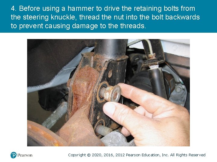 4. Before using a hammer to drive the retaining bolts from the steering knuckle,