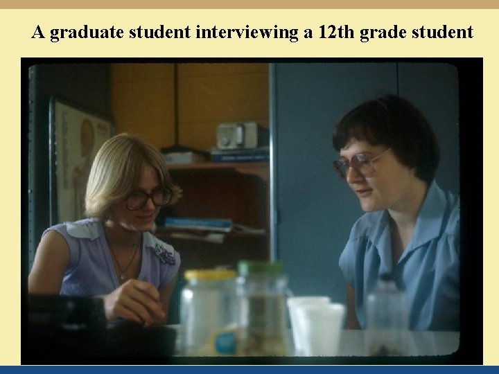 A graduate student interviewing a 12 th grade student 