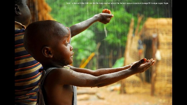 'Rain' - a Bassari tribe child catches the long-awaited rain at the harvest season