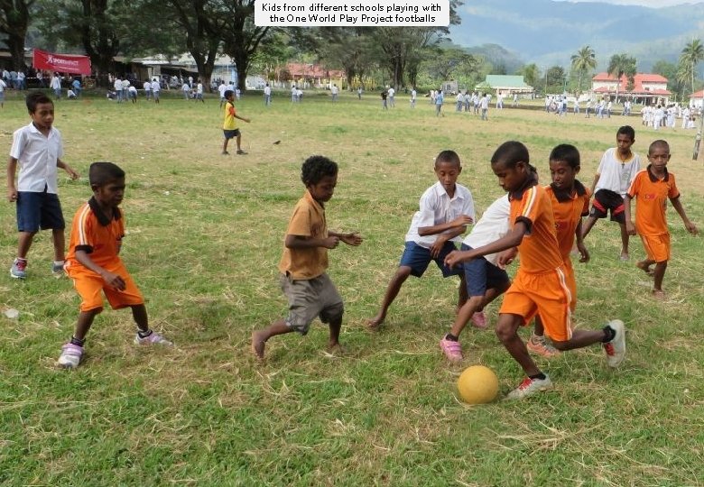 Kids from different schools playing with the One World Play Project footballs 