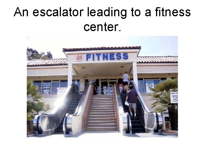 An escalator leading to a fitness center. 