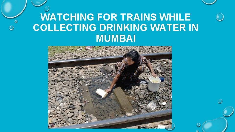 WATCHING FOR TRAINS WHILE COLLECTING DRINKING WATER IN MUMBAI 