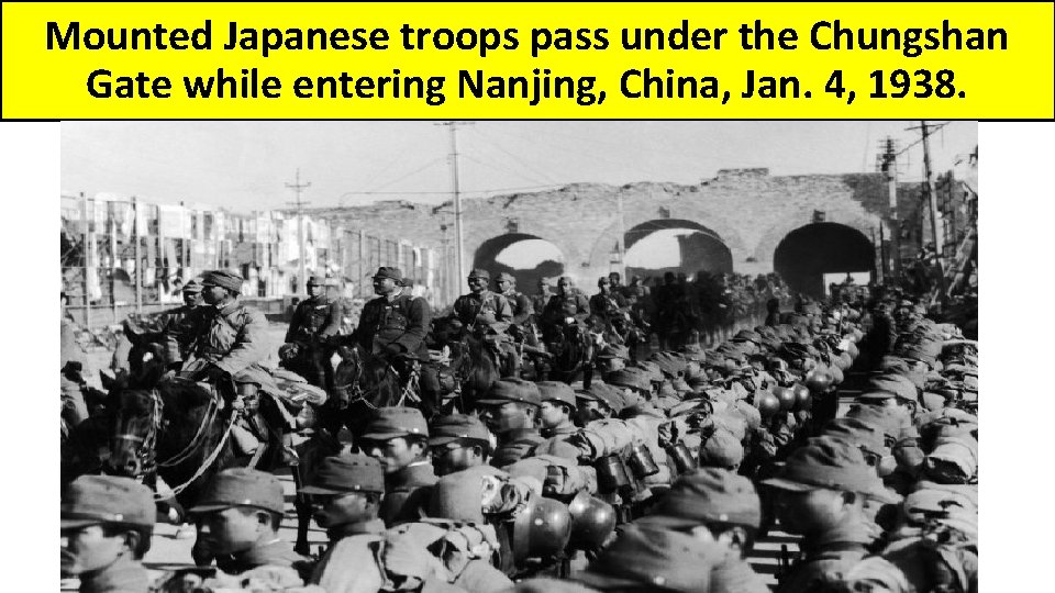 Mounted Japanese troops pass under the Chungshan Gate while entering Nanjing, China, Jan. 4,