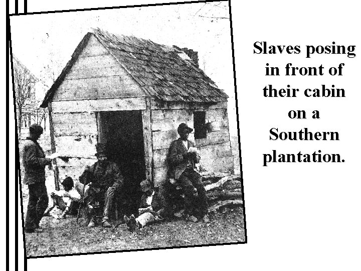 Slaves posing in front of their cabin on a Southern plantation. 