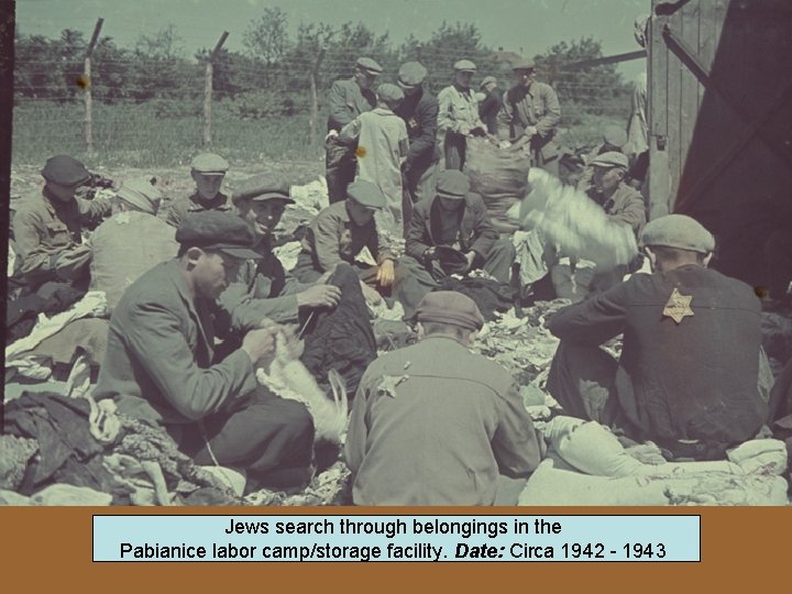 Jews search through belongings in the Pabianice labor camp/storage facility. Date: Circa 1942 -