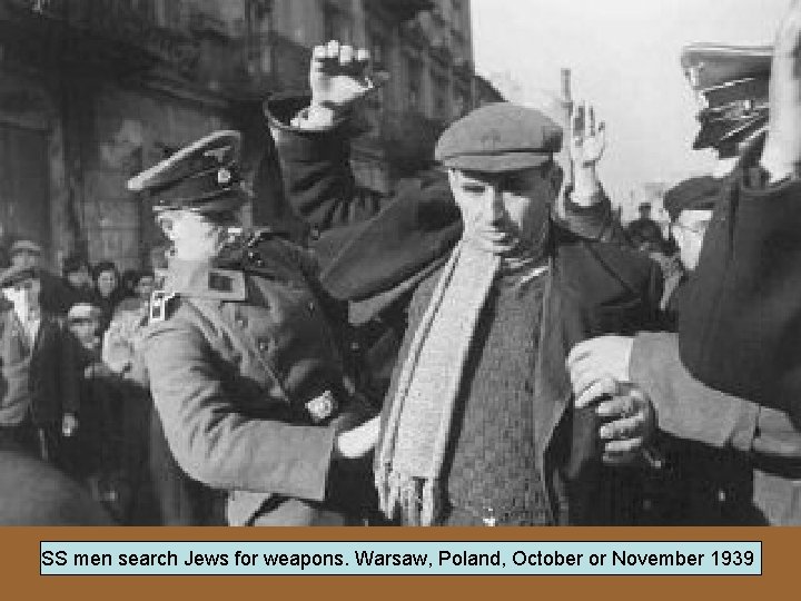 SS men search Jews for weapons. Warsaw, Poland, October or November 1939 