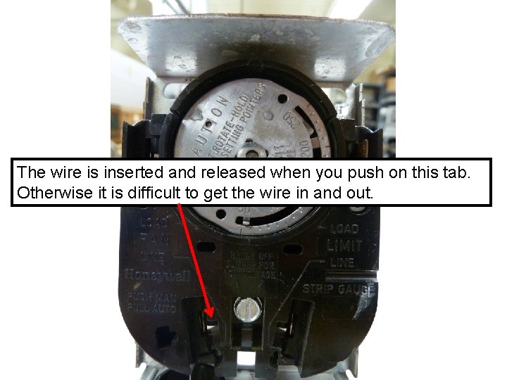 The wire is inserted and released when you push on this tab. Otherwise it