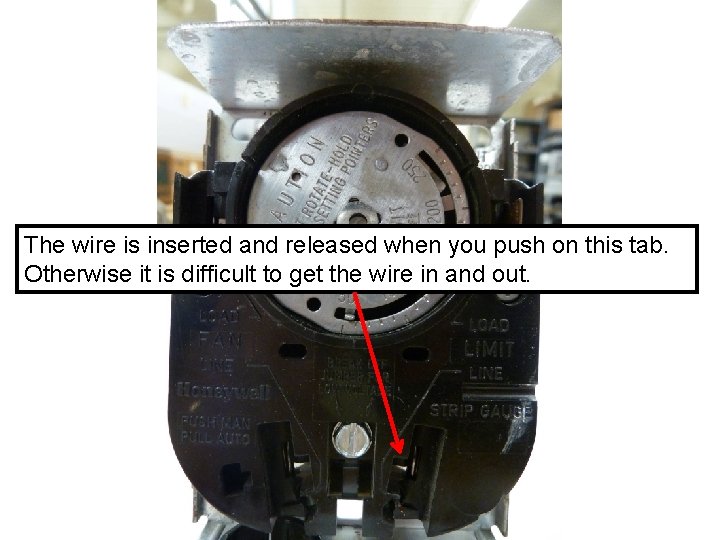 The wire is inserted and released when you push on this tab. Otherwise it