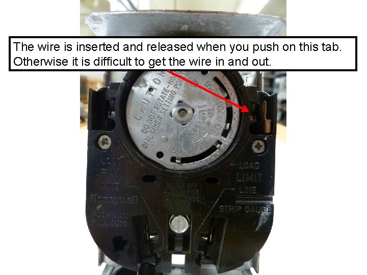 The wire is inserted and released when you push on this tab. Otherwise it