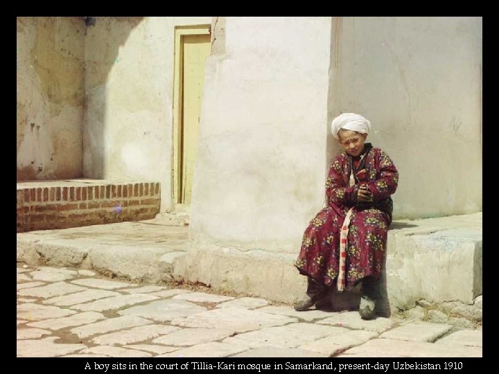 A boy sits in the court of Tillia-Kari mosque in Samarkand, present-day Uzbekistan 1910