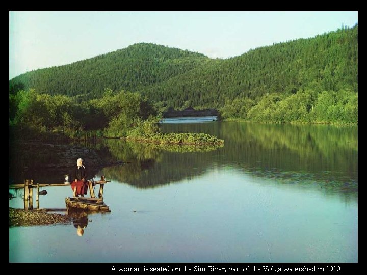 A woman is seated on the Sim River, part of the Volga watershed in