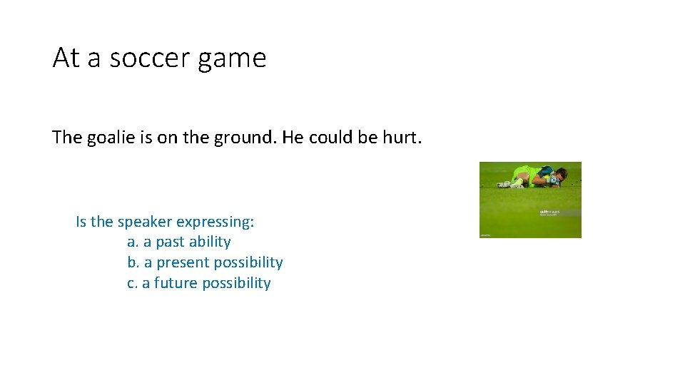 At a soccer game The goalie is on the ground. He could be hurt.