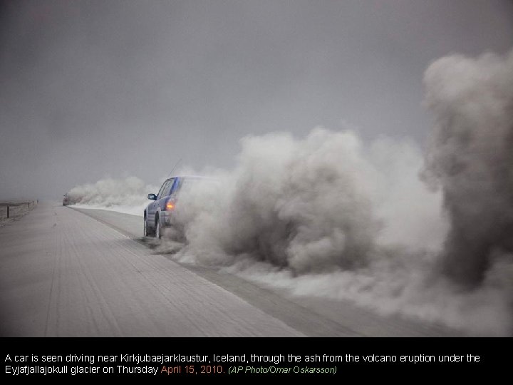 A car is seen driving near Kirkjubaejarklaustur, Iceland, through the ash from the volcano