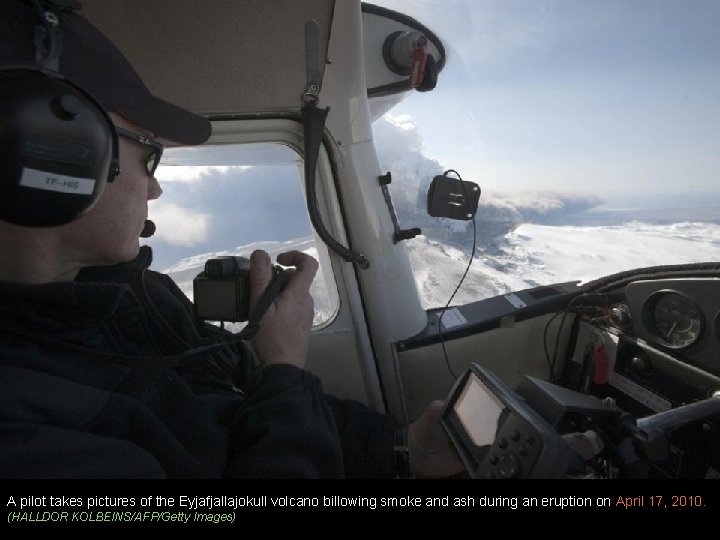 A pilot takes pictures of the Eyjafjallajokull volcano billowing smoke and ash during an