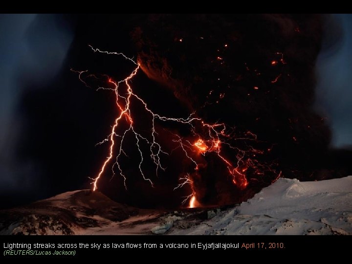 Lightning streaks across the sky as lava flows from a volcano in Eyjafjallajokul April