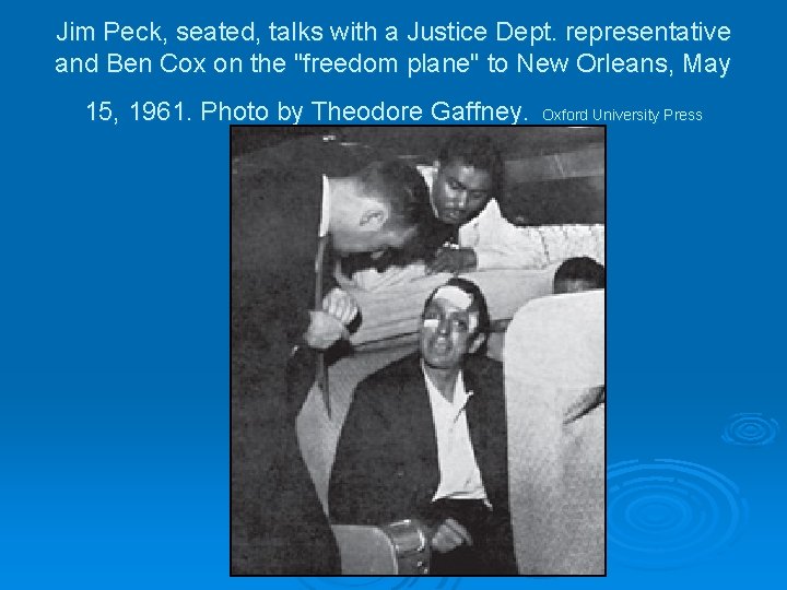 Jim Peck, seated, talks with a Justice Dept. representative and Ben Cox on the