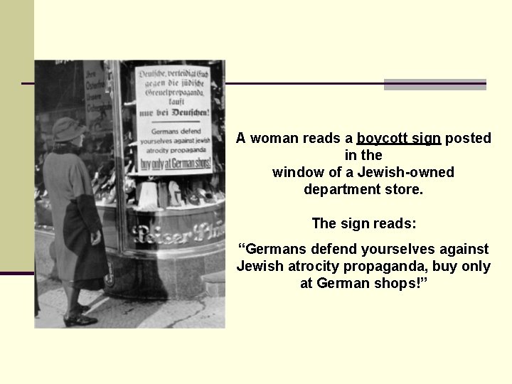 A woman reads a boycott sign posted in the window of a Jewish-owned department