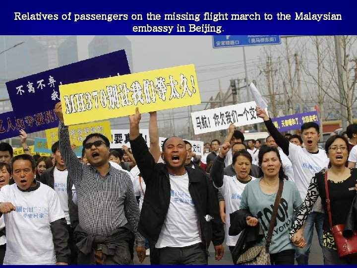 Relatives of passengers on the missing flight march to the Malaysian embassy in Beijing