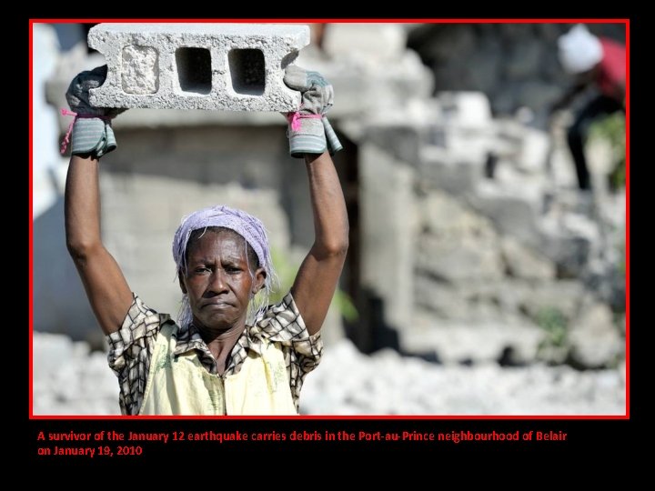 A survivor of the January 12 earthquake carries debris in the Port-au-Prince neighbourhood of