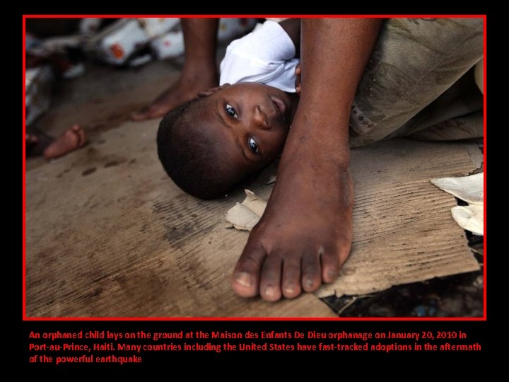 An orphaned child lays on the ground at the Maison des Enfants De Dieu