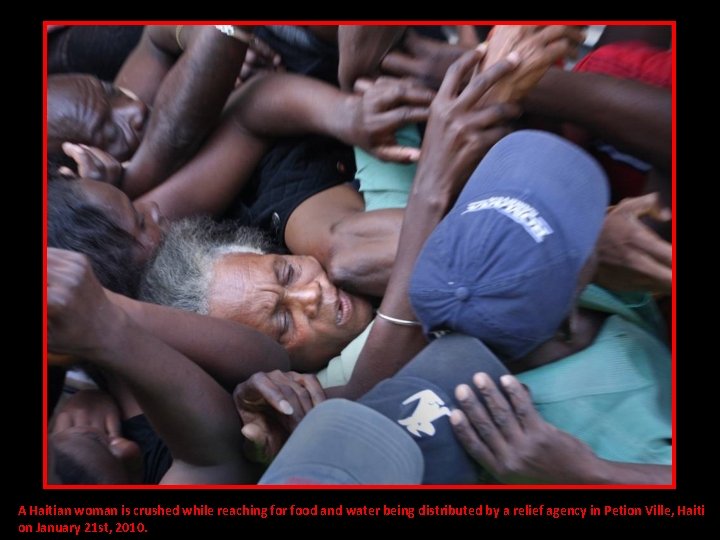 A Haitian woman is crushed while reaching for food and water being distributed by