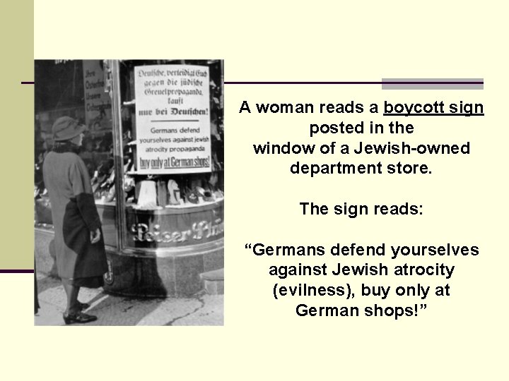 A woman reads a boycott sign posted in the window of a Jewish-owned department A woman reads a boycott sign posted in the window of a Jewish-owned department