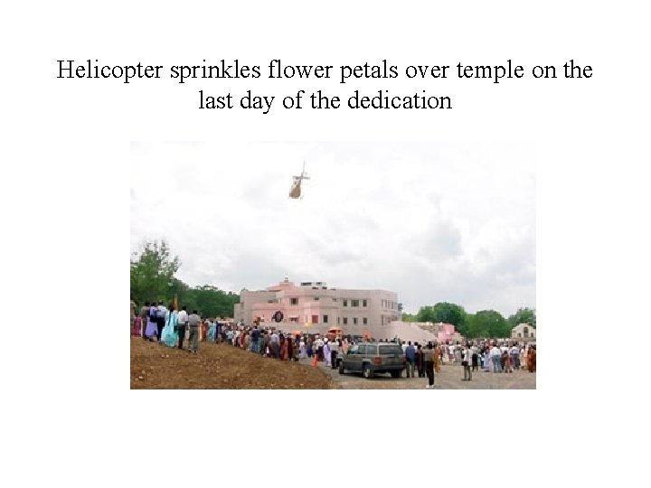 Helicopter sprinkles flower petals over temple on the last day of the dedication 