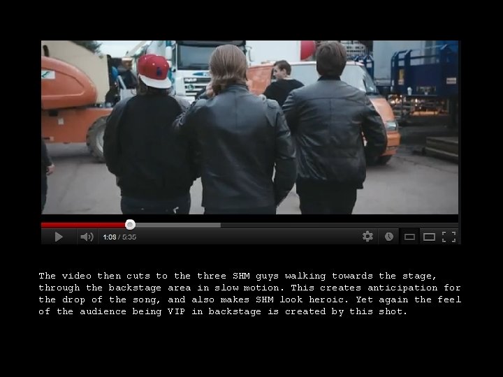 The video then cuts to the three SHM guys walking towards the stage, through