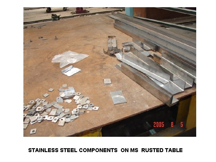 STAINLESS STEEL COMPONENTS ON MS RUSTED TABLE 