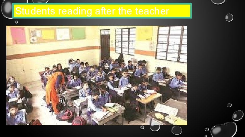 Students reading after the teacher 