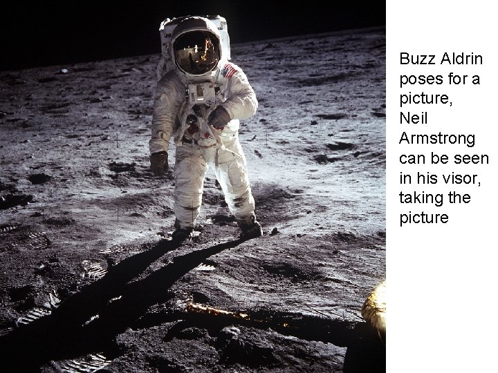 Buzz Aldrin poses for a picture, Neil Armstrong can be seen in his visor,