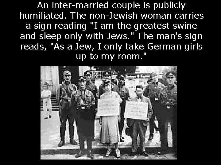 An inter-married couple is publicly humiliated. The non-Jewish woman carries a sign reading "I