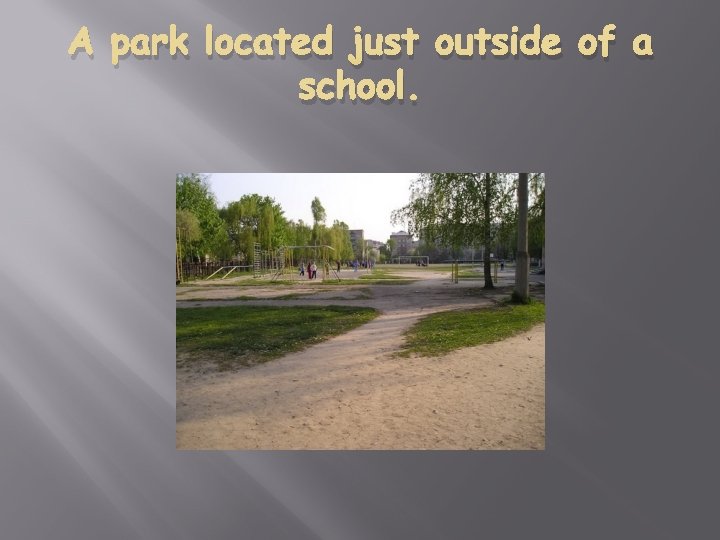 A park located just outside of a school. 