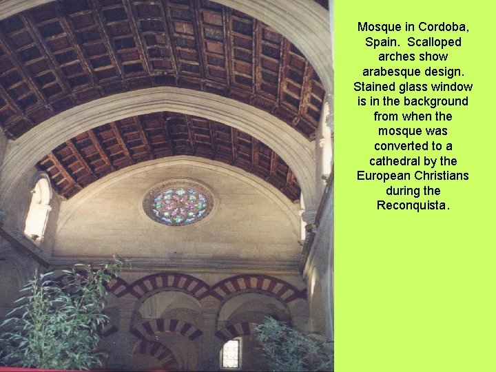 Mosque in Cordoba, Spain. Scalloped arches show arabesque design. Stained glass window is in