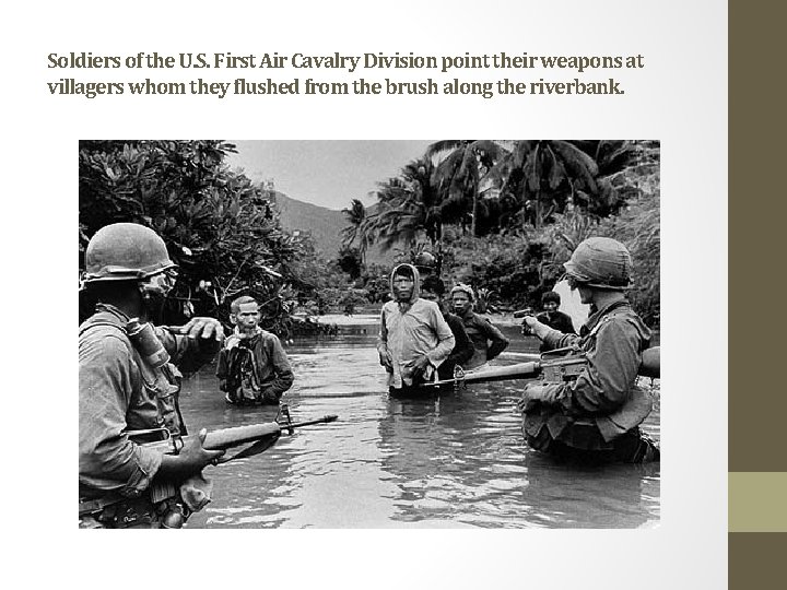 Soldiers of the U. S. First Air Cavalry Division point their weapons at villagers