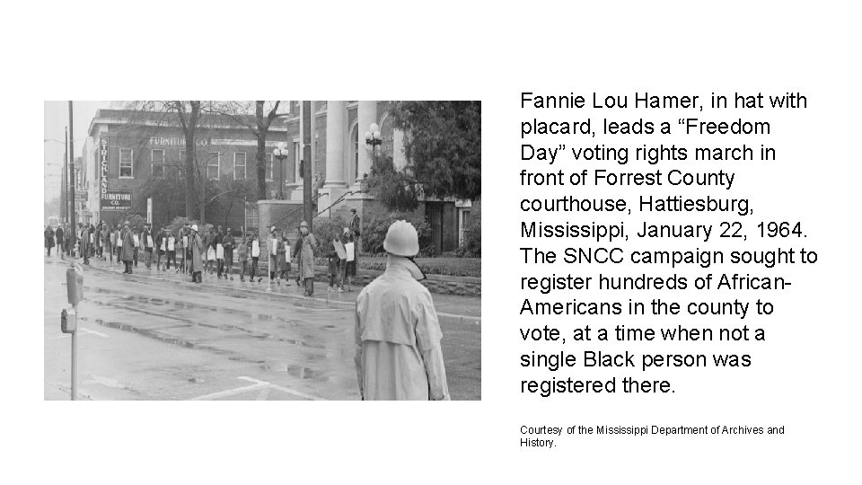 Fannie Lou Hamer, in hat with placard, leads a “Freedom Day” voting rights march
