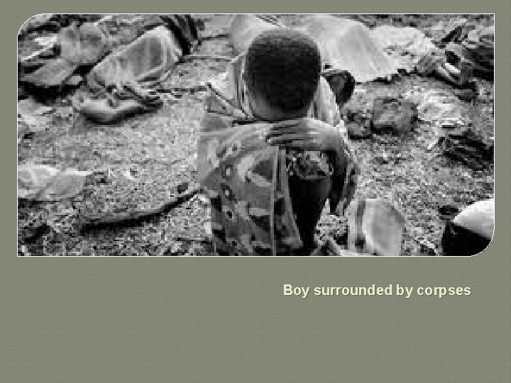 Boy surrounded by corpses 